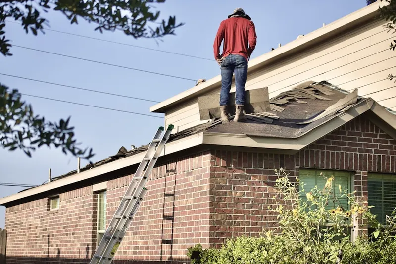 Professional roofer working on a residential roof in Garnet
